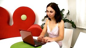 A black haired woman with sensitive nipples is getting cum on her